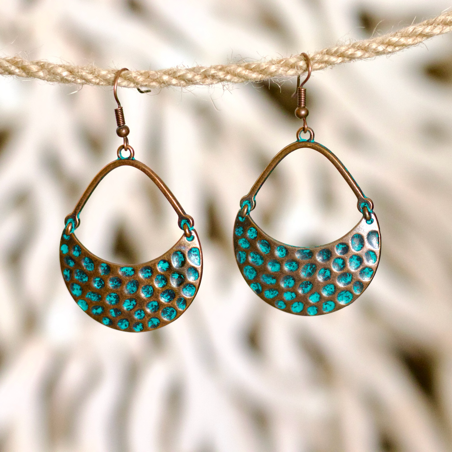 Bohemian-style crescent earrings crafted from copper-toned metal
